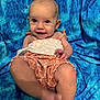 baby, smiling, child, portrait, blue_background, sitting, cute, happy, infant, clothing, fabric, skin, foot, hand, eyes, head, person, playful, cheerful, photography