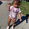 accessories, beads, child, colorful, concrete, cute, fashion, grass, hair_accessories, necklaces, outdoor, person, playful, shadow, sidewalk, socks, summer, sunlight, toddler, young_child