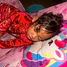 Aviora joined the competition — help win amazing prizes! child, sleeping, portrait, indoors, bed, bedspread, red_dress, shiny_clothing, curly_hair, hair_bun, closed_eyes, face, hand, colorful, pink, rainbow, textile, bedding, resting, cute