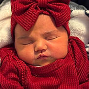 Aurora joined the competition — help win amazing prizes! baby, sleeping, red_clothing, headband, bow, infant, cute, face, closed_eyes, soft_texture, warm, child, portrait, cozy, newborn, adorable, knitwear, resting, indoors, blanket