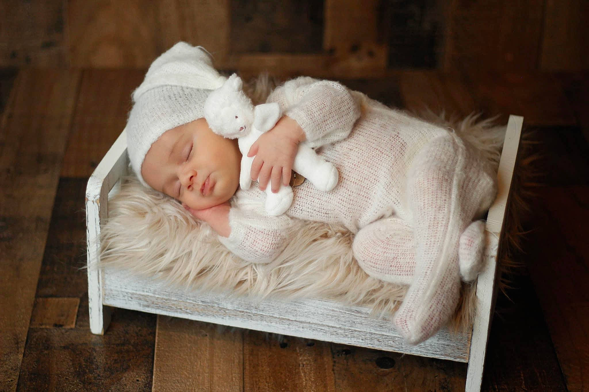 Colt is registered to the contest to win money with this photo: baby, baby_products, baby_sleeping, baby_toddler_clothing, cheek, child, comfort, flooring, grass, hardwood, headwear, infant_bed, linens, person, portrait_photography, room, sitting, skin, toddler, wood