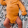 baby, bed, bodypart, bonnet, cap, clothing, face, finger, furniture, glove, hand, hat, head, hosiery, newborn, pants, person, photography, portrait, sock