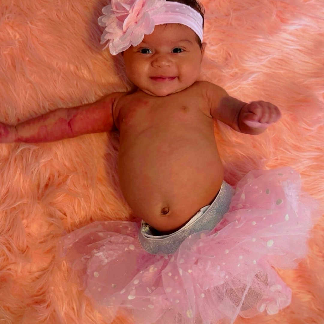 Nevaeh joined the competition — help win amazing prizes! accessories, baby, bodypart, bonnet, cap, clothing, costume, dress, face, finger, hand, happy, hat, head, newborn, person, photography, portrait, sitting, smile