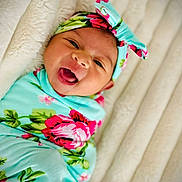 Nevaeh is registered to the contest to win money with this photo: baby, bodypart, bonnet, clothing, dress, face, finger, flower, hand, happy, hat, head, laughing, newborn, person, photography, plant, portrait, rose, smile