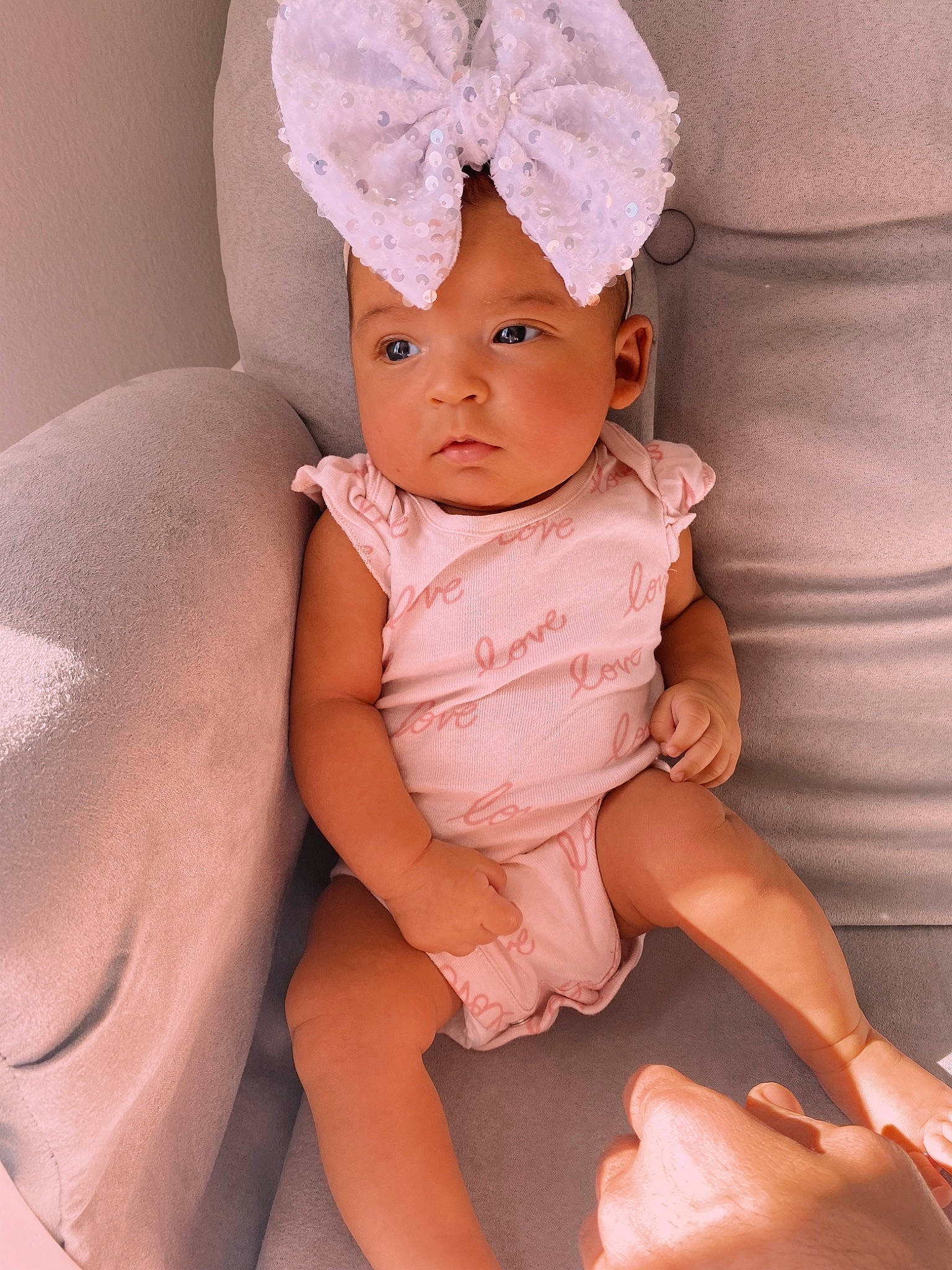 Kenley joined the competition — help win amazing prizes! baby, baby_toddler_clothing, cap, comfort, face, finger, headgear, headwear, human_body, human_leg, knee, leg, linens, lip, nail, neck, person, pink, skin, thigh