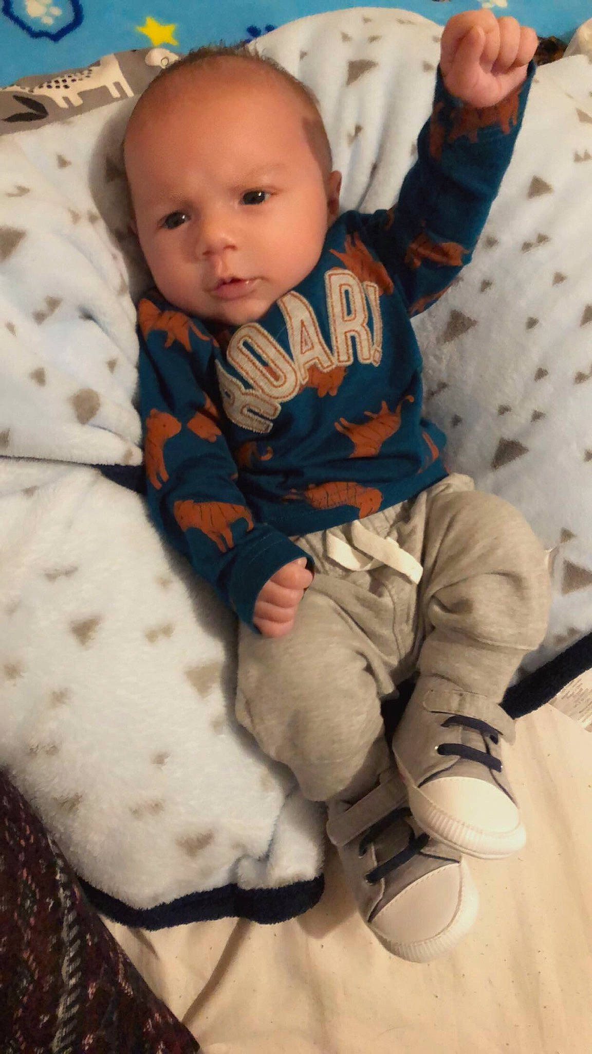 Kaleb is registered to the contest to win money with this photo: arm, baby, baby_toddler_clothing, cheek, child, comfort, cool, eye, face, finger, happy, khaki_pants, leg, pattern, people, person, skin, sleeve, thigh, toddler