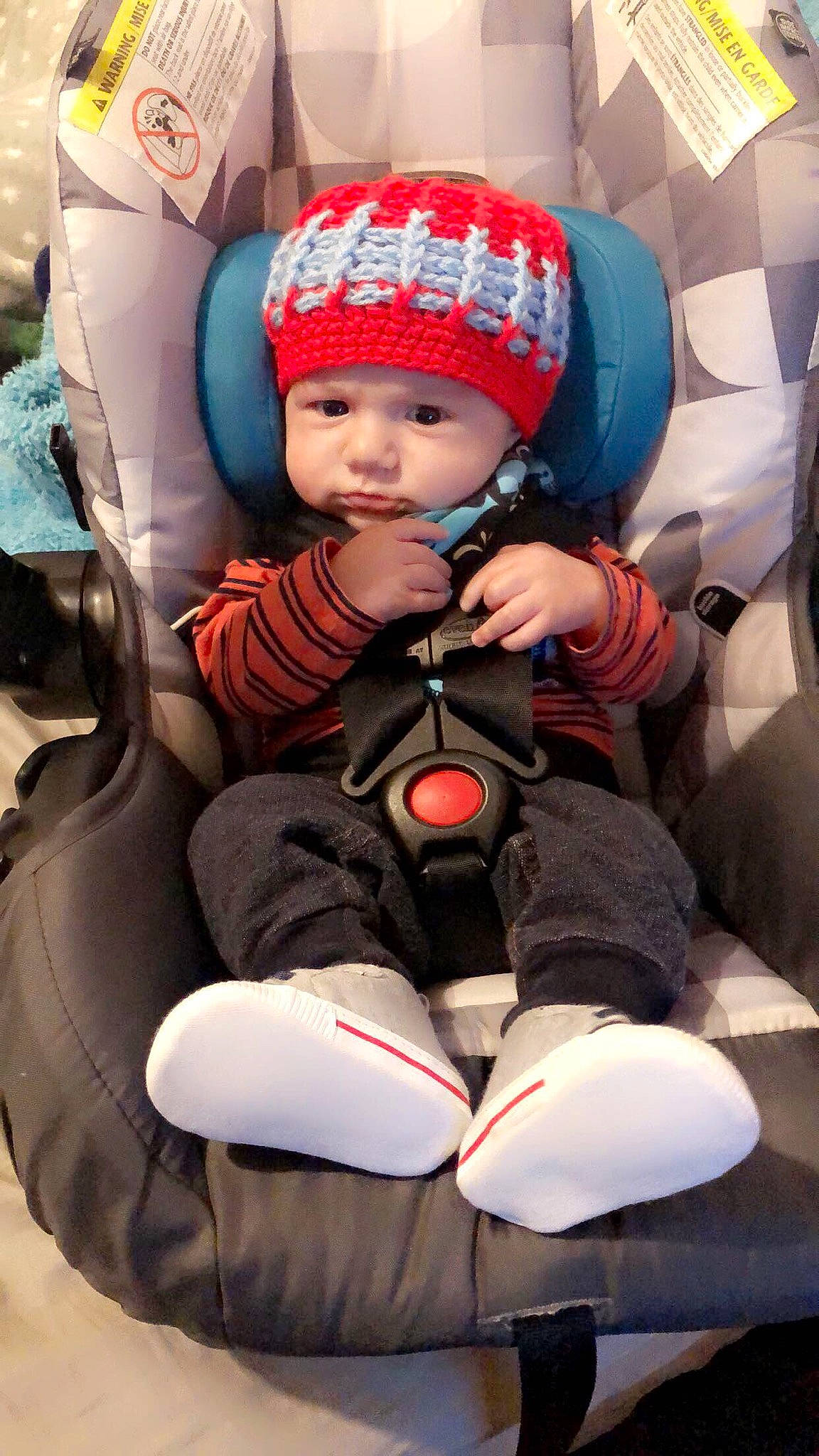 Kaleb joined the competition — help win amazing prizes! baby, baby_carriage, baby_products, baby_safety, baby_toddler_clothing, beanie, cap, car_seat, carmine, child, comfort, face, fun, headwear, lap, leisure, person, personal_protective_equipment, sitting, sneakers