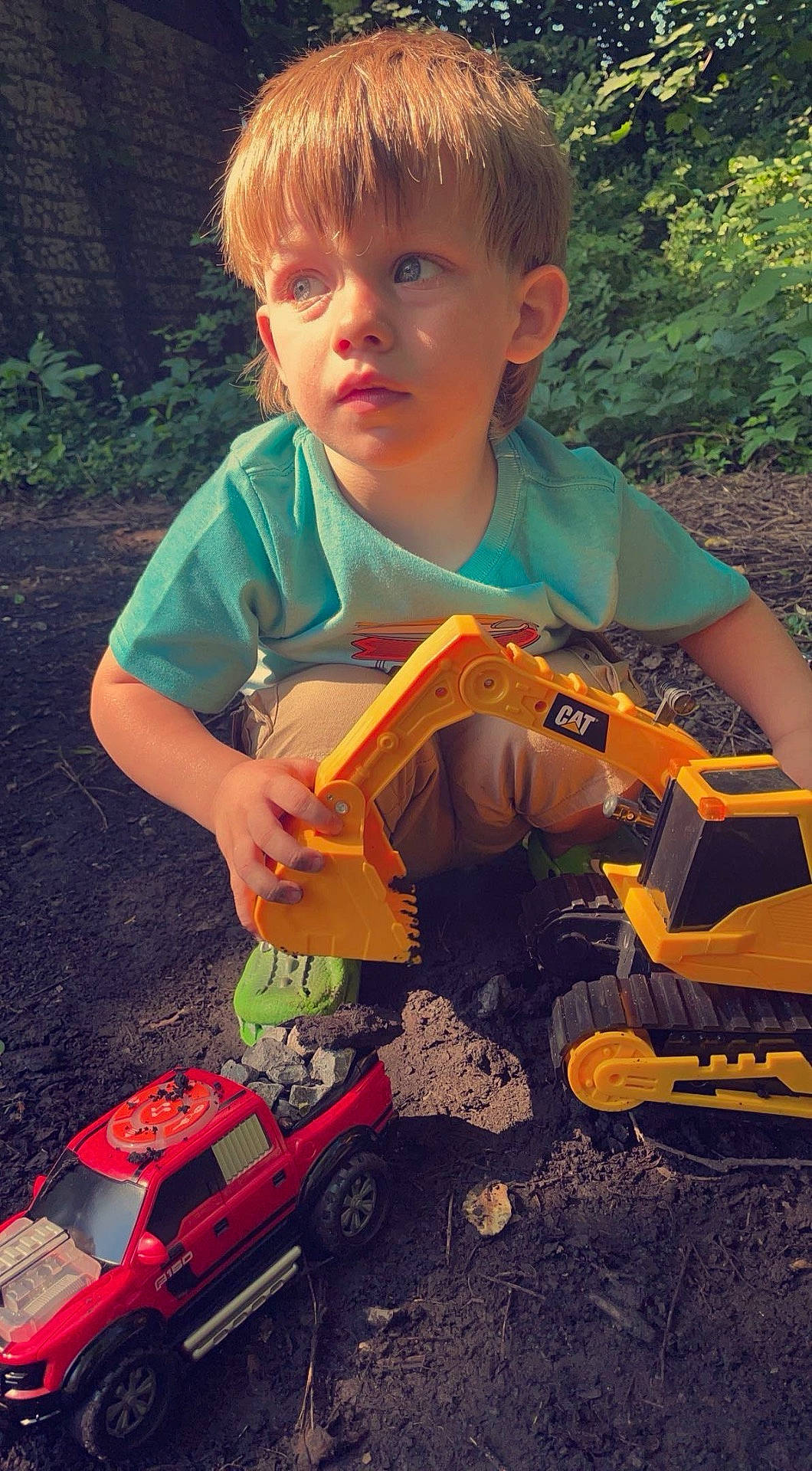 Noah is registered to the contest to win money with this photo: boy, car, child, face, grass, head, machine, male, nature, outdoors, person, photography, plant, portrait, soil, toy, transportation, vegetation, vehicle, wheel