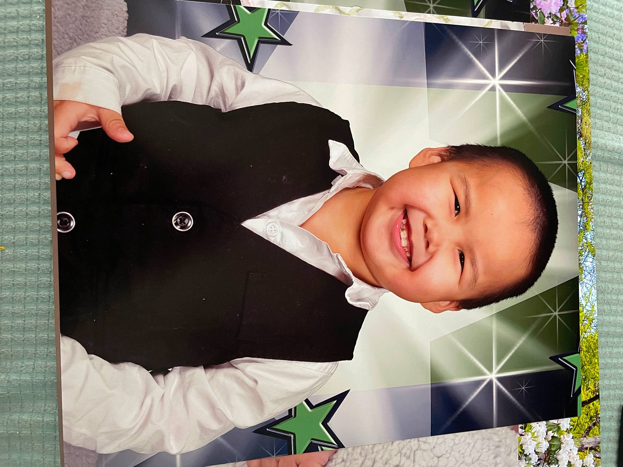 Desmond is registered to the contest to win money with this photo: baby, baby_laughing, baby_products, baby_toddler_clothing, child, facial_expression, font, fun, gesture, grass, happy, joy, pattern, person, photo_caption, photomontage, product, room, sleeve, smile