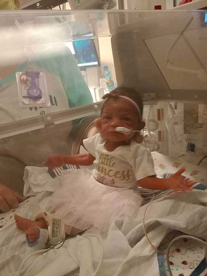 Amiyah is registered to the contest to win money with this photo: baby, baby_products, baby_safety, baby_toddler_clothing, bed, bed_sheet, bedding, birth, child, childbirth, comfort, event, hospital, linens, person, room, sitting, skin, smile, t_shirt