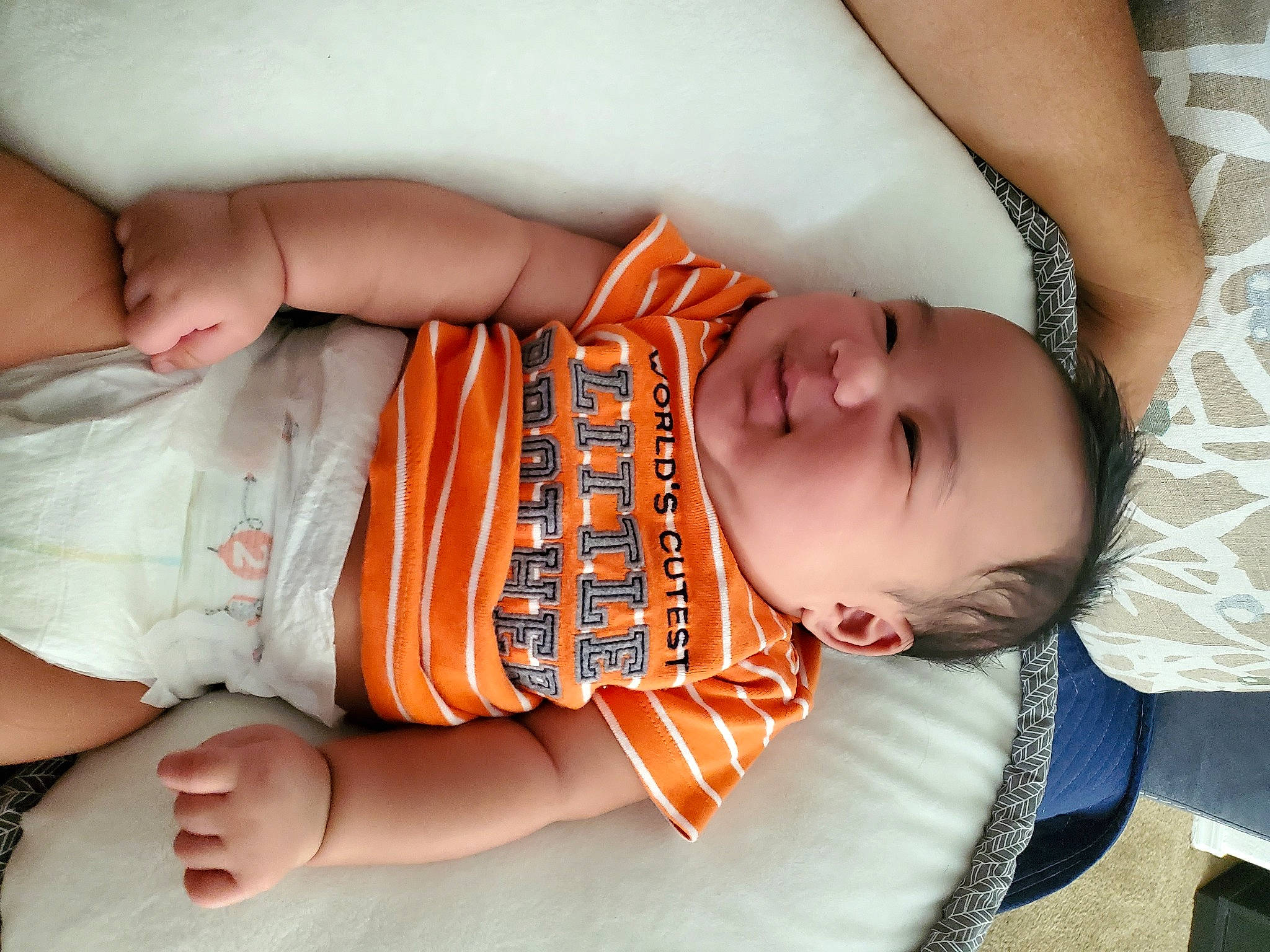 Hezekiah is registered to the contest to win money with this photo: abdomen, arm, baby, baby_sleeping, child, fashion_accessory, finger, hand, happy, leg, nail, nap, orange, person, product, skin, sleep, toddler, trunk