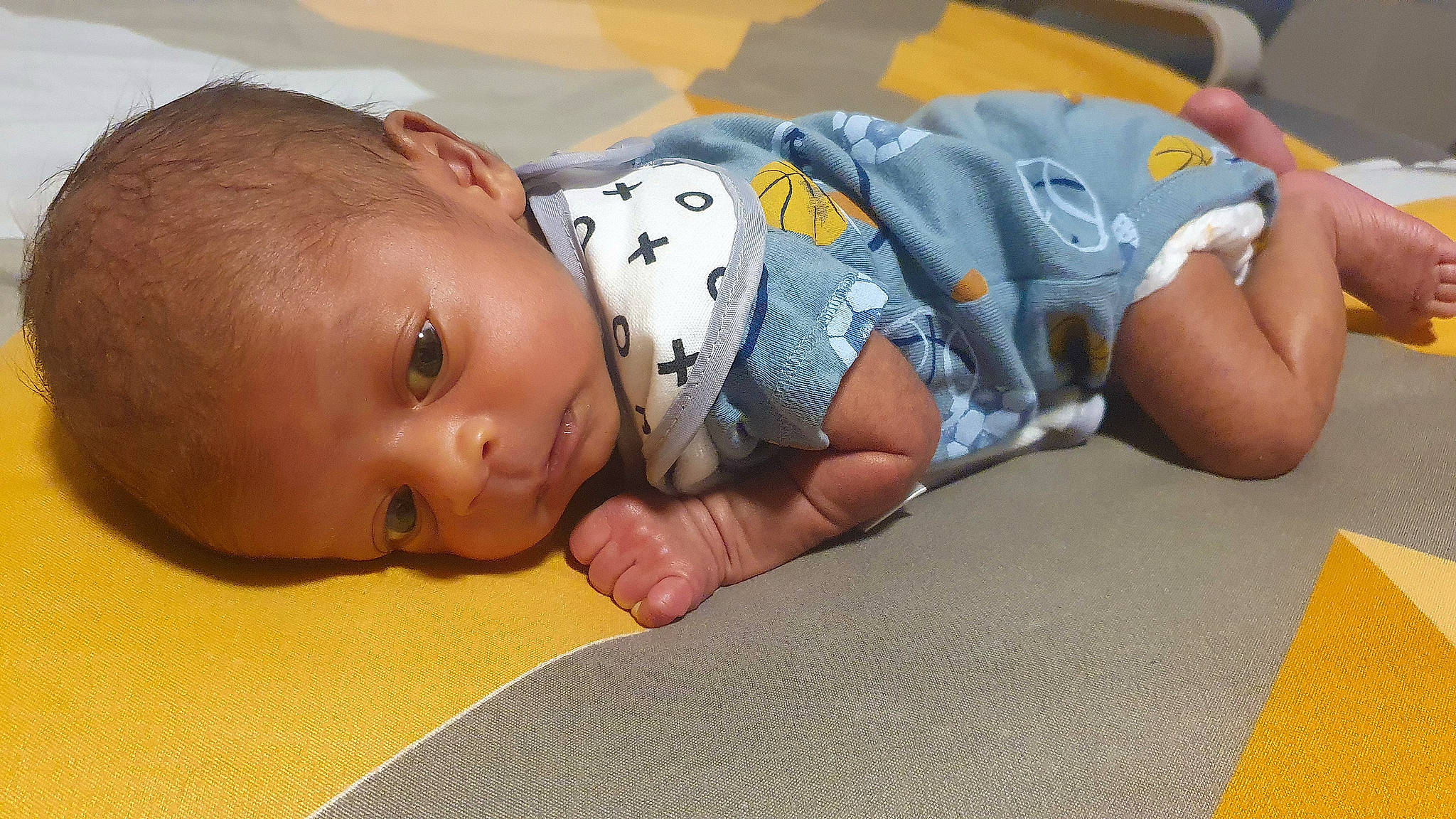 Amogh is registered to the contest to win money with this photo: baby, baby_products, baby_toddler_clothing, bedtime, cheek, child, comfort, flooring, fun, happy, human_body, linens, person, play, room, sitting, skin, sleep, toddler, tummy_time