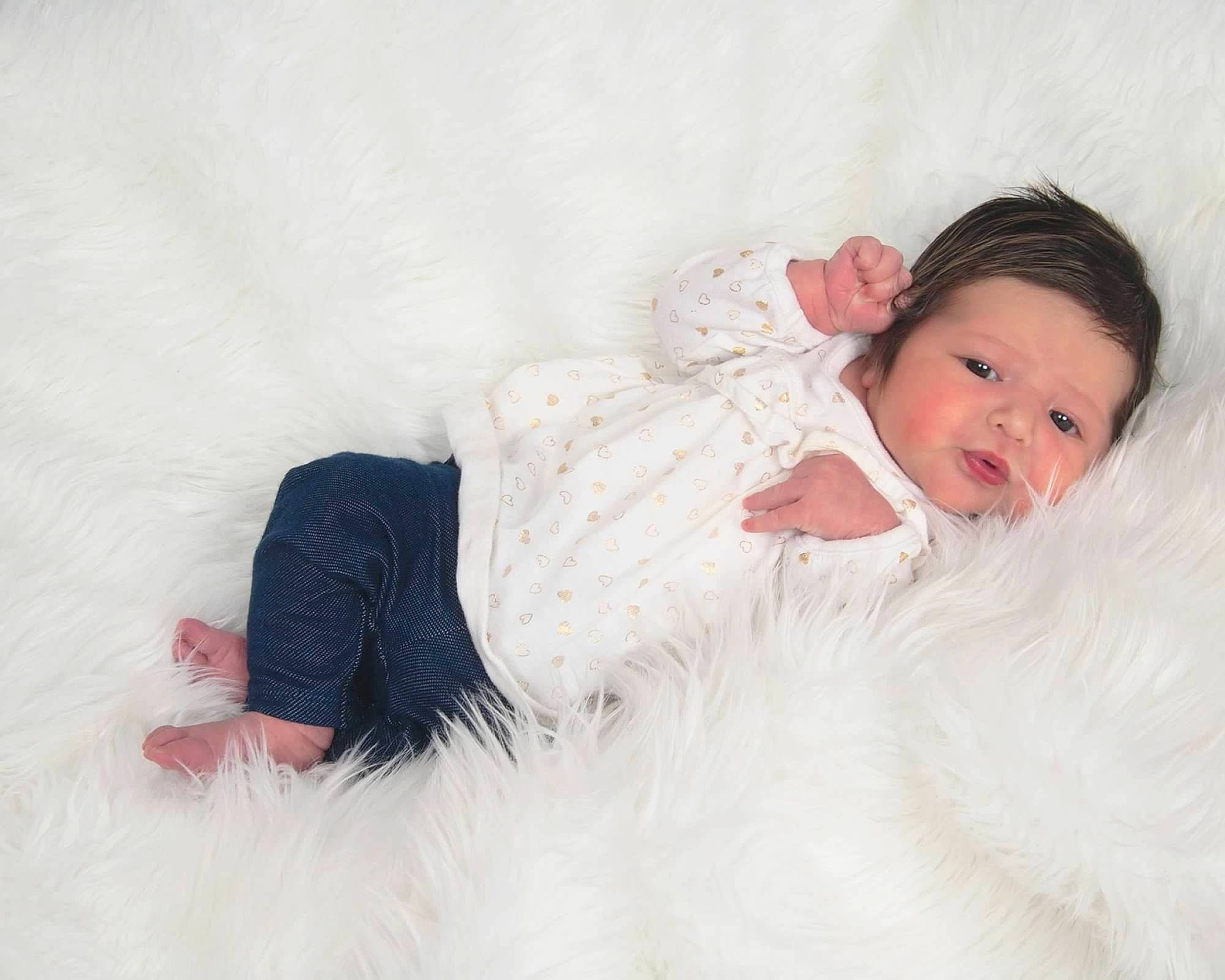 Brianna is registered to the contest to win money with this photo: baby, baby_toddler_clothing, child, comfort, couch, dress, embellishment, fashion_accessory, flash_photography, fur, hair_accessory, happy, linens, pattern, person, photo_shoot, portrait_photography, sitting, sleeve, smile