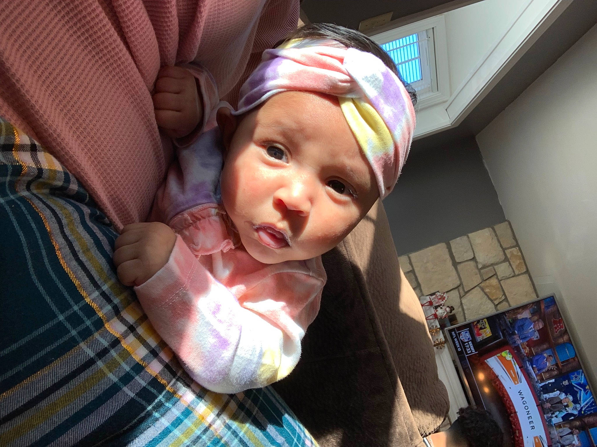 Emelia is registered to the contest to win money with this photo: baby, baby_toddler_clothing, cap, car_seat, cheek, child, comfort, eyewear, fashion_accessory, fun, happy, headwear, helmet, pattern, person, personal_protective_equipment, plaid, selfie, skin, tartan