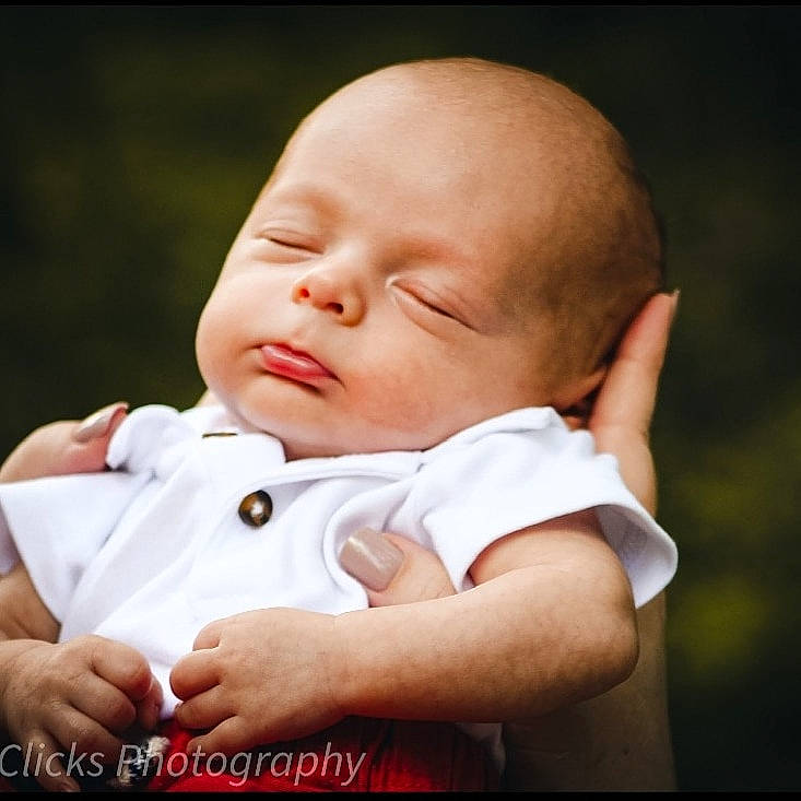 Grant is registered to the contest to win money with this photo: baby, baby_toddler_clothing, cheek, child, comfort, eye, face, flash_photography, fun, gesture, grass, happy, head, lip, people_in_nature, person, plant, sitting, skin, sleeve