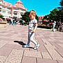 Teo a rejoint le concours — aidez-le/la à gagner de superbes lots ! child, boy, walking, outdoor, daylight, building, plaza, pavement, shoes, shadow, flowers, trees, people, sky, casual_clothing, hat, urban, tourists, summer, vacation