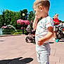 Teo participe au concours pour gagner de l'argent avec cette photo : toddler, child, outdoors, sunny, park, flowers, stroller, people, pavement, casual_clothing, talking, side_profile, daylight, trees, family, recreation, playful, summer, shoes, shadow