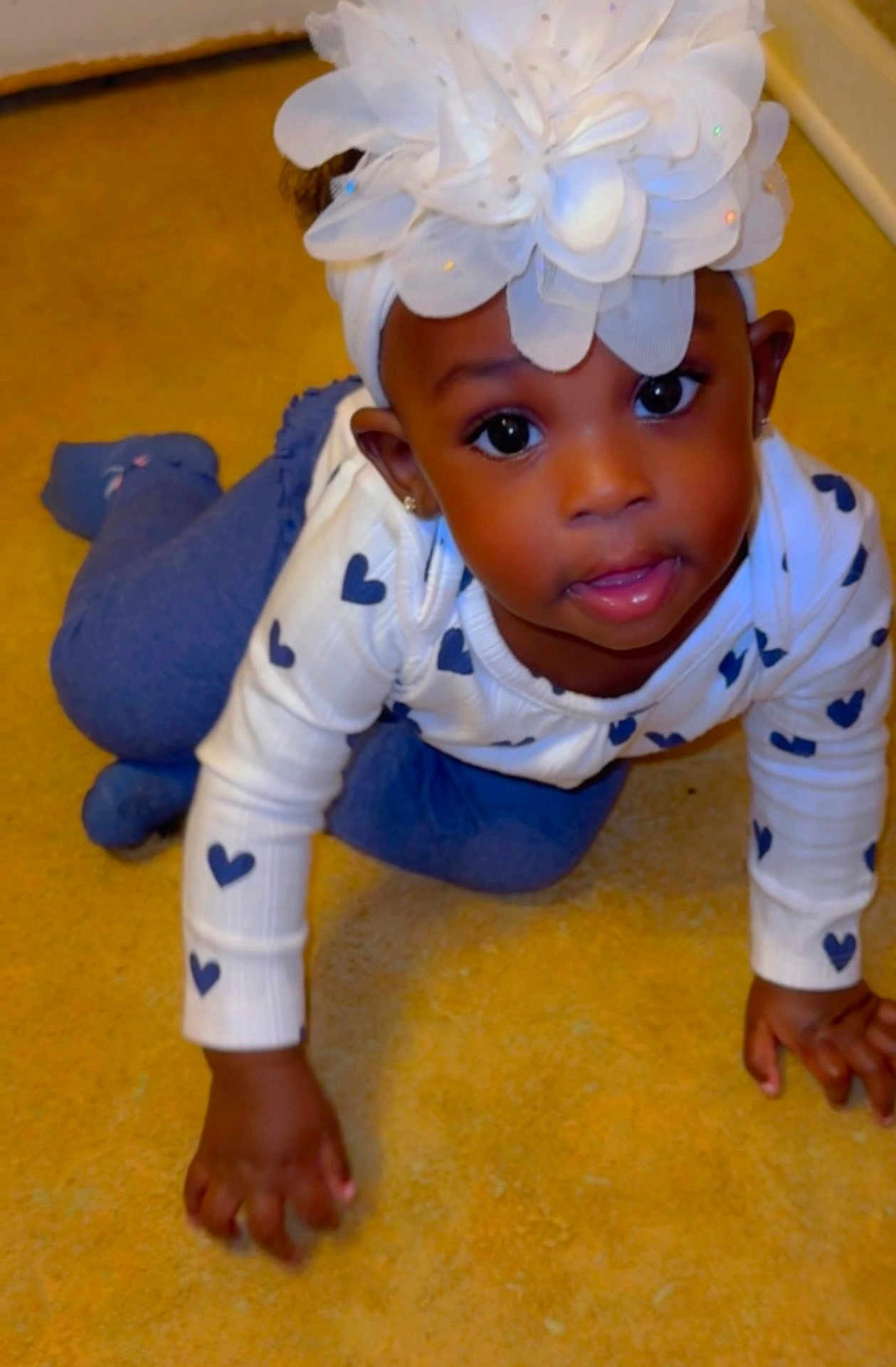 Jaior Milani joined the competition — help win amazing prizes! baby, blue_hearts, blue_pants, carpet, child, crawling, curious, cute, face, feet, floor, flower, hands, headband, indoors, portrait, smiling, toddler, white_sweater, young_child