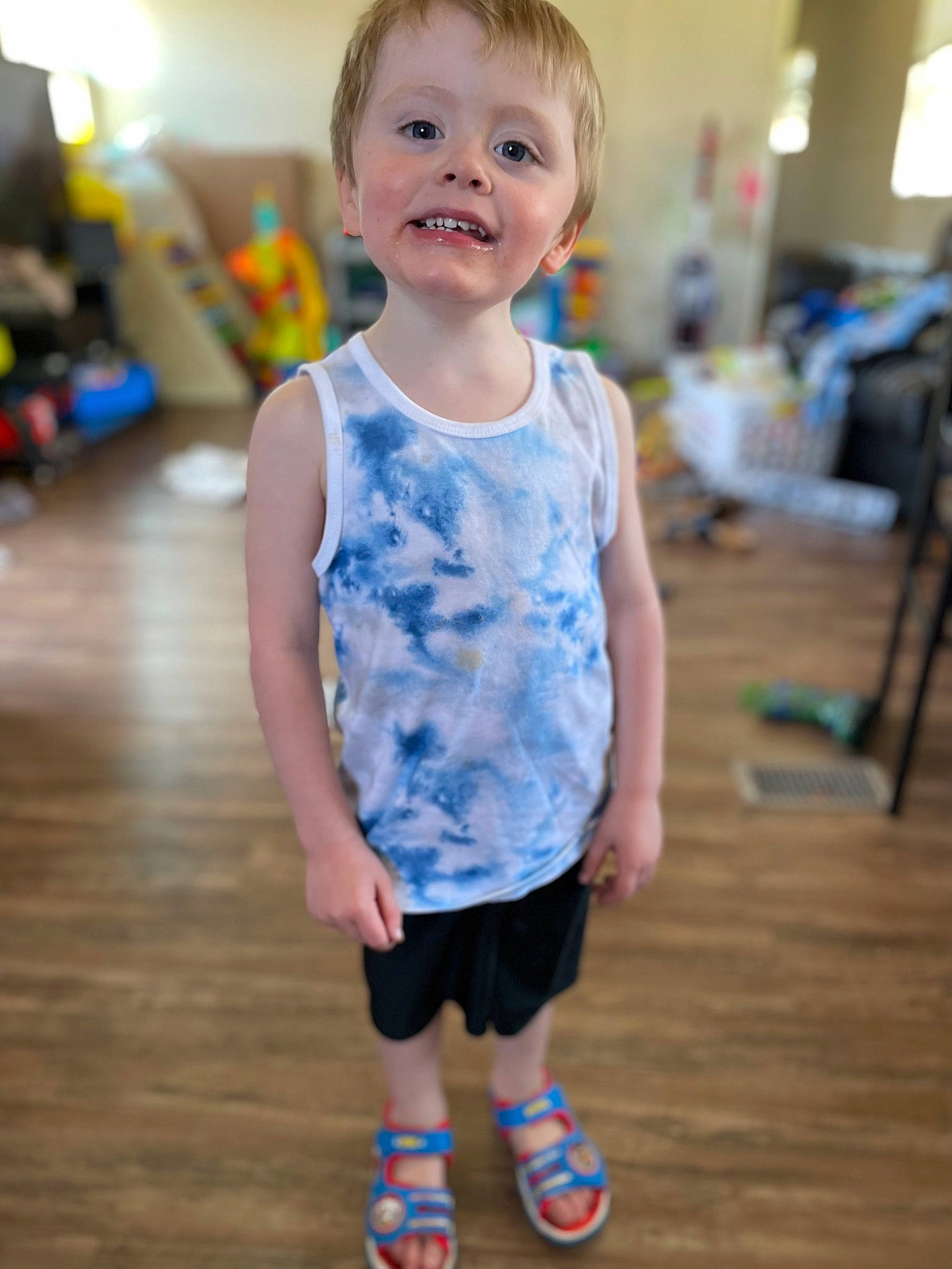 Aiden is registered to the contest to win money with this photo: baby_toddler_clothing, electric_blue, facial_expression, flooring, fun, happy, head, human_body, knee, leisure, person, recreation, shorts, skin, sleeve, smile, sportswear, standing, t_shirt, toddler