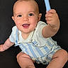baby, background, barefoot, blue_spoon, child, cute, face, foot, hand, happy, indoors, infant, light_skin, overalls, portrait, short_hair, sitting, smiling, striped_clothing, texture