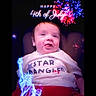 baby, child, smiling, tshirt, text_overlay, fireworks, statue_of_liberty, 4th_of_july, celebration, holiday, portrait, sitting, happy, indoors, red, white, blue, digital_art, glow, festive
