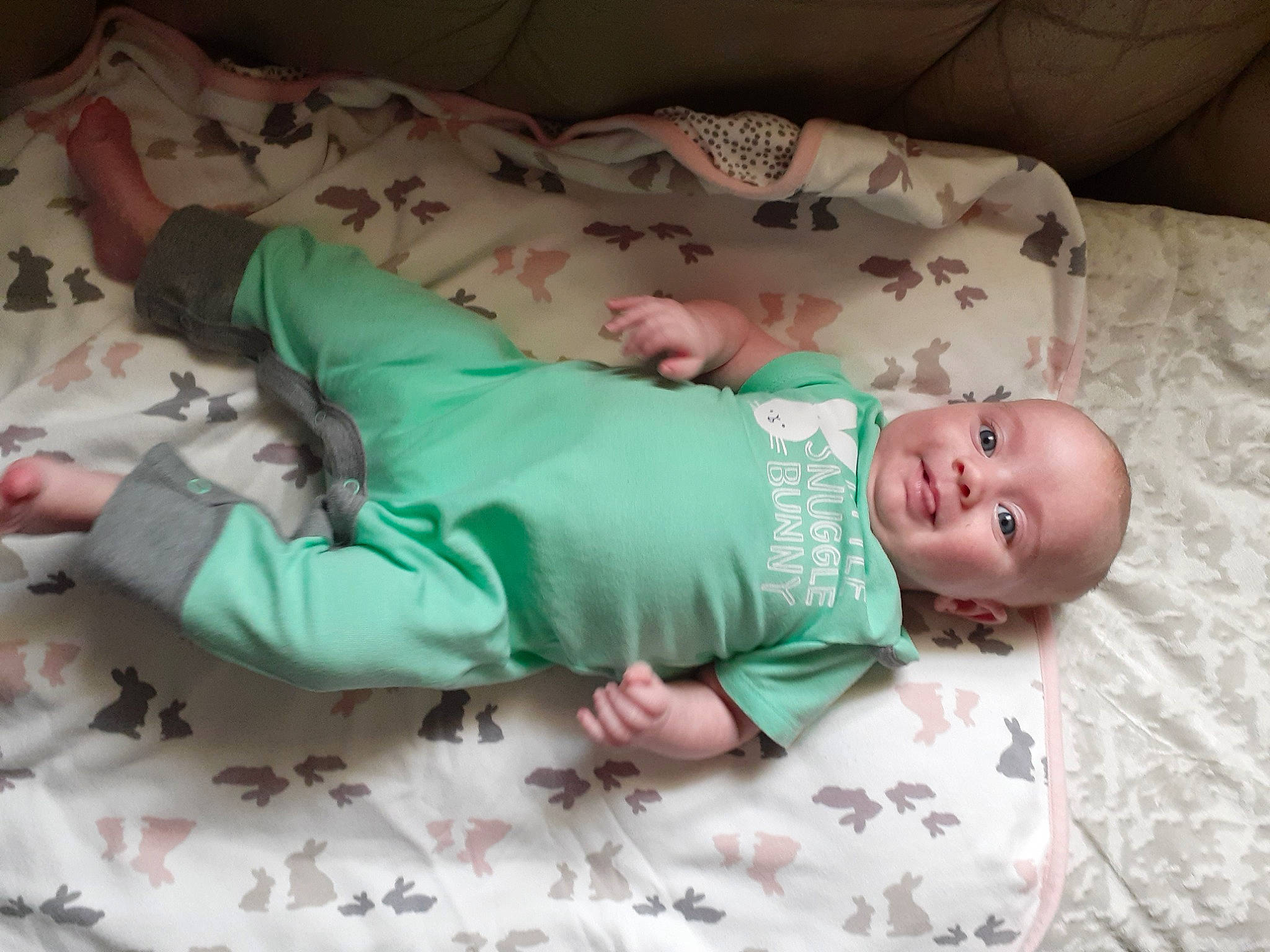 Violet is registered to the contest to win money with this photo: arm, baby, baby_safety, baby_toddler_clothing, bed, child, comfort, eye, face, finger, hand, head, human_body, leg, mammal, person, skin, sleeve, textile, toddler