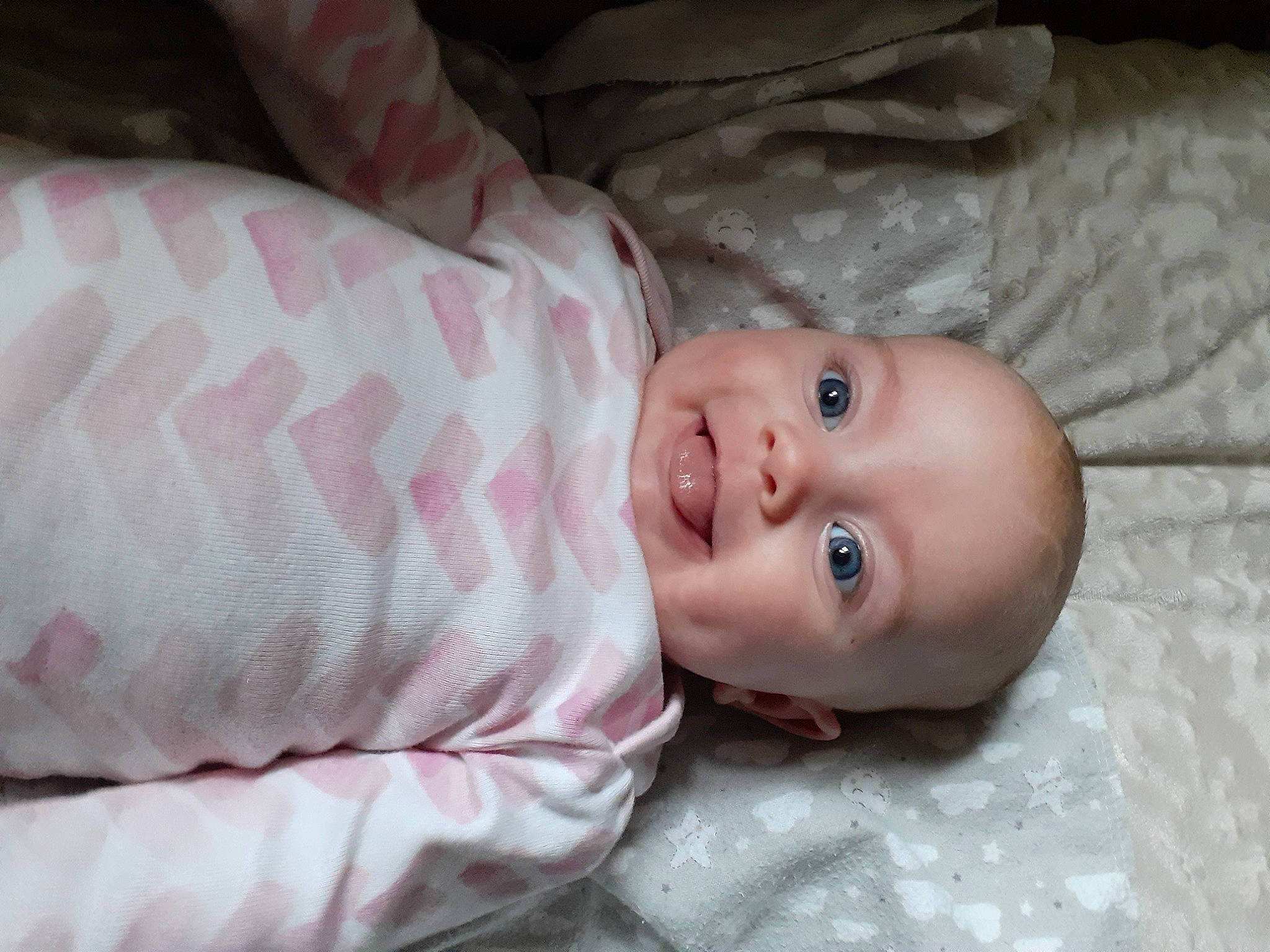 Violet is registered to the contest to win money with this photo: baby, baby_toddler_clothing, cheek, child, comfort, eye, eyebrow, face, facial_expression, flooring, linens, lip, mammal, mouth, nose, person, portrait_photography, skin, sleeve, smile