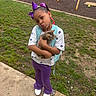 Queen Dracco joined the competition — help win amazing prizes! child, girl, cat, kitten, playground, grass, sidewalk, purple_clothing, white_shoes, backpack, hair_bow, pouting, outdoor, play_equipment, tabby_cat, holding, cute, portrait, smile, casual