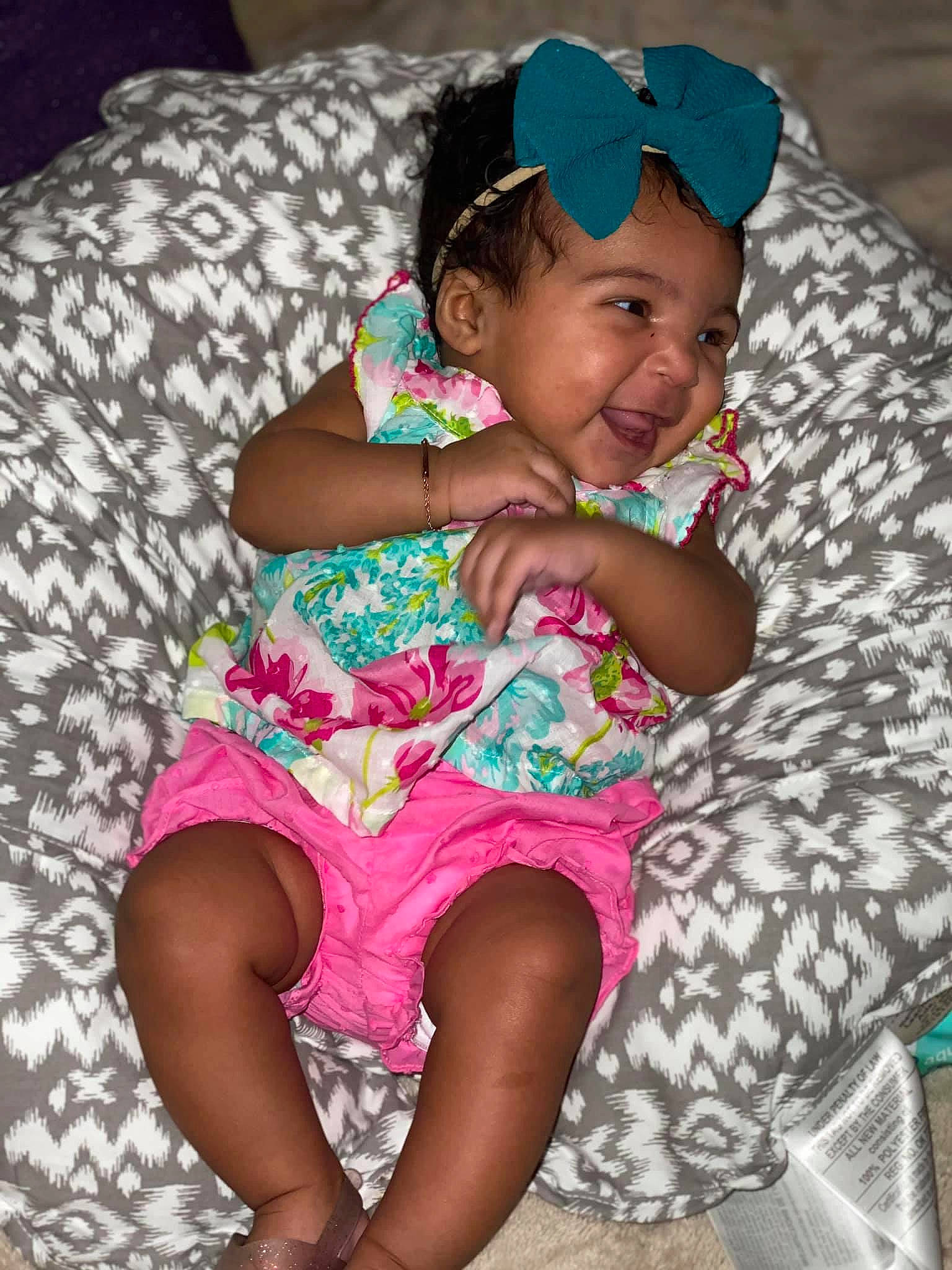 Zahra joined the competition — help win amazing prizes! baby, child, finger, headwear, person, pink, sitting, smile, toddler