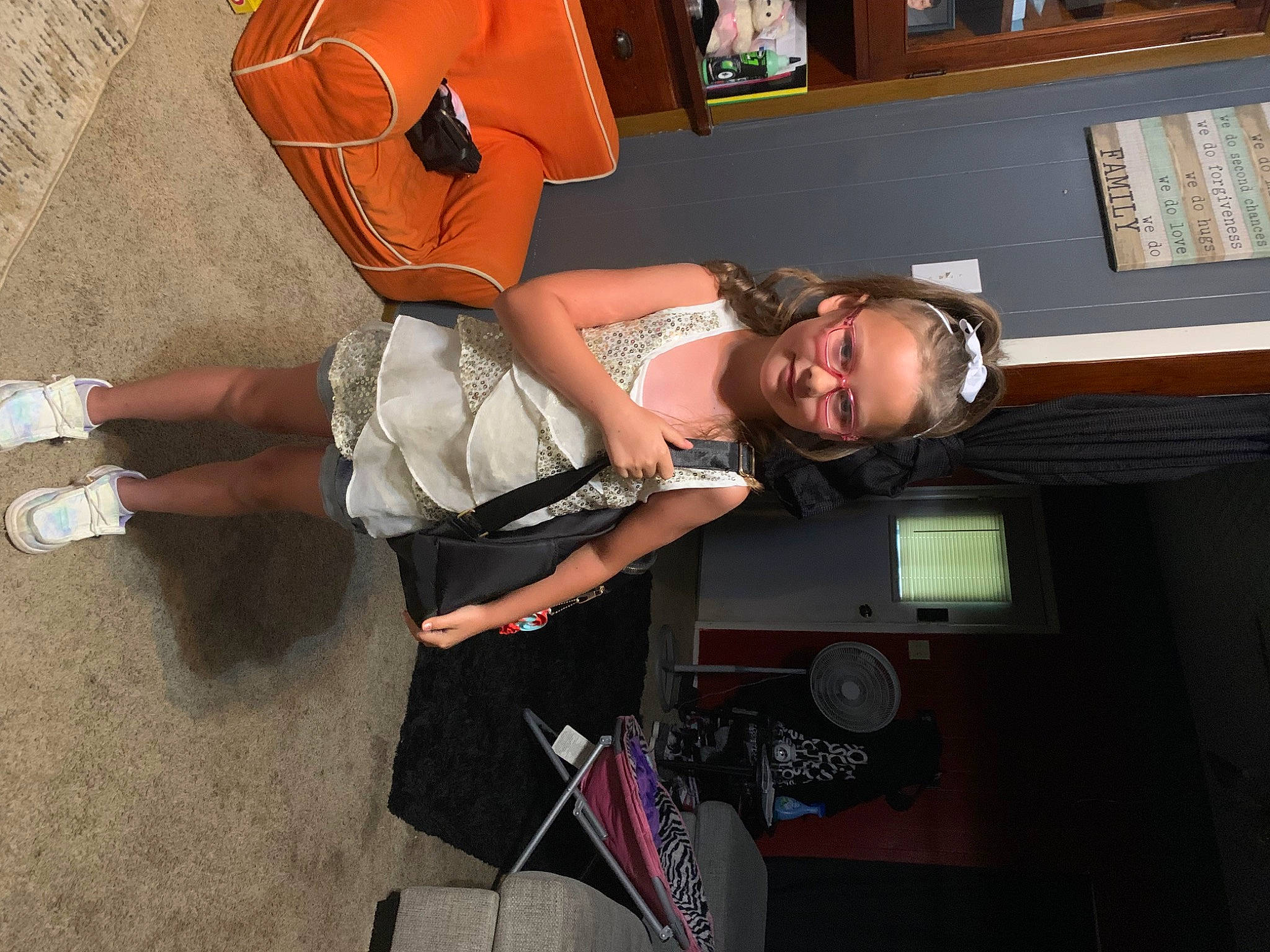 Tessa is registered to the contest to win money with this photo: audio_equipment, bag, eyewear, flooring, fun, human_leg, joint, joy, knee, luggage_and_bags, person, picture_frame, room, sandal, smile, thigh, wrist