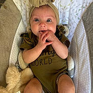 Cora joined the competition — help win amazing prizes! baby, infant, child, headband, hand, fingers, onesie, seat, blanket, toy, soft, cute, indoor, closeup, portrait, expression, skin, eyes, clothing, comfort