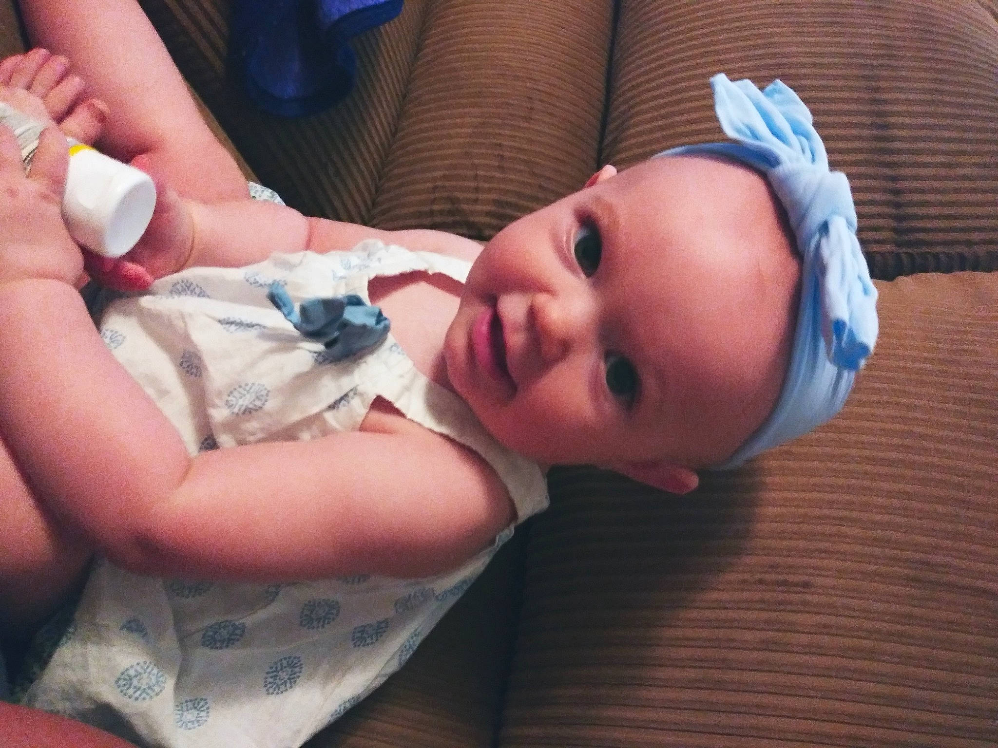 Amelia is registered to the contest to win money with this photo: baby, baby_products, baby_toddler_clothing, cheek, child, comfort, eyelash, finger, flooring, headwear, human_leg, linens, lip, mouth, nail, nose, person, room, skin, thumb