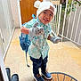 Toahei participe au concours pour gagner de l'argent avec cette photo : toddler, child, hat, mittens, backpack, smile, shoes, shirt, door, doormat, hallway, floor, railing, plant, indoor, standing, happy, cute, playful, clothing