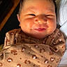 Eliana joined the competition — help win amazing prizes! baby, newborn, smile, face, clothing, onesie, pattern, brown, hair, skin, infant, cute, resting, cozy, portrait, person, happy, young, child, indoors