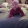 Eliana joined the competition — help win amazing prizes! baby, child, bedroom, bed, blanket, pillow, curtains, window, crawling, smiling, hat, jacket, indoors, cozy, happy, person, furniture, soft_lighting, playful, leopard_print