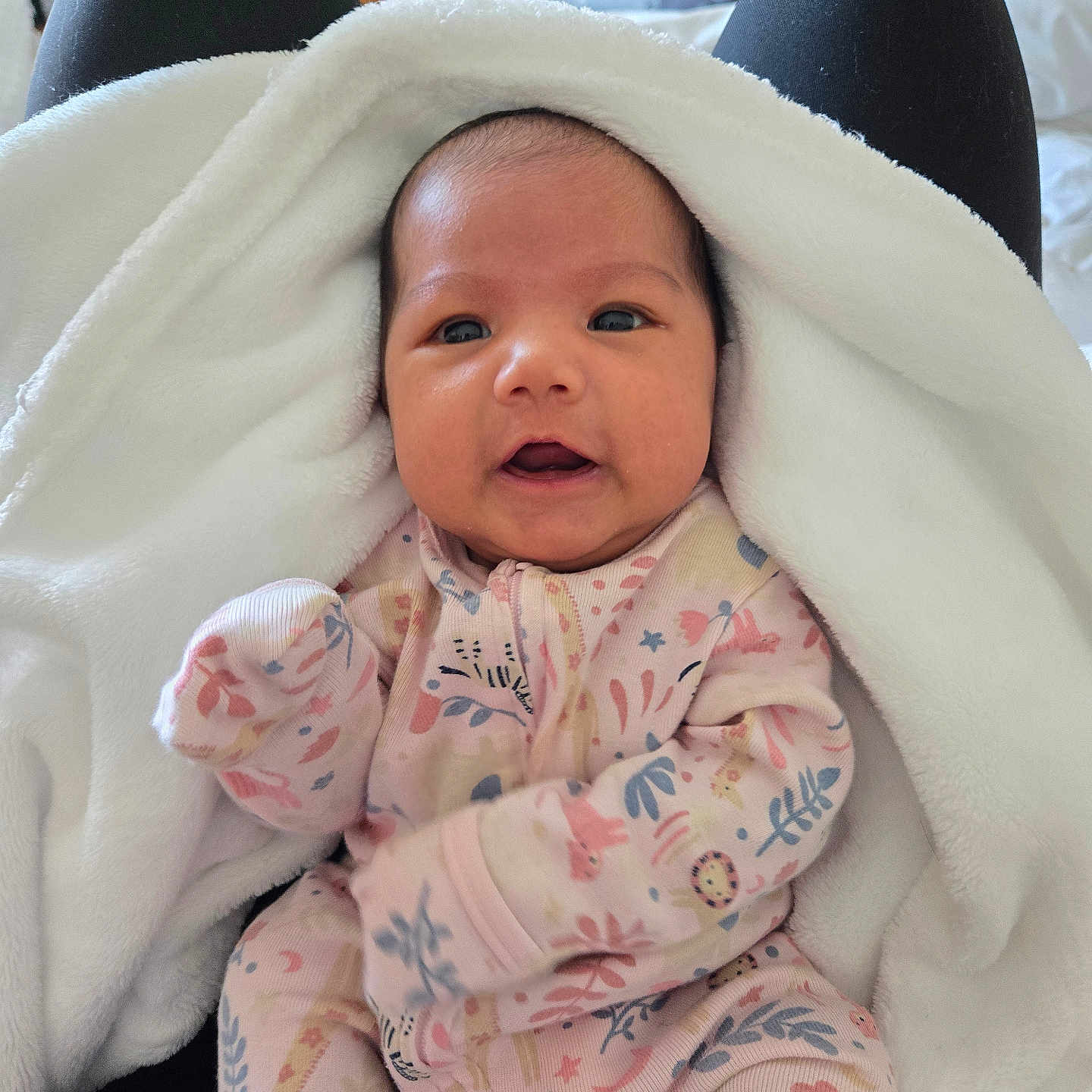 Shiloh Rose is registered to the contest to win money with this photo: baby, black_pants, blanket, child, clothing, cute, eyes, face, floral_pattern, hand, indoor, infant, lap, newborn, onesie, person, portrait, soft_texture, warm, wooden_furniture