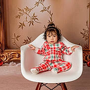 Sofia joined the competition — help win amazing prizes! child, toddler, baby, chair, white_chair, plaid_pajamas, pajamas, holiday, christmas, ornaments, decorative_frame, portrait, studio, indoor, cozy, face, hair, sitting, cute, expression