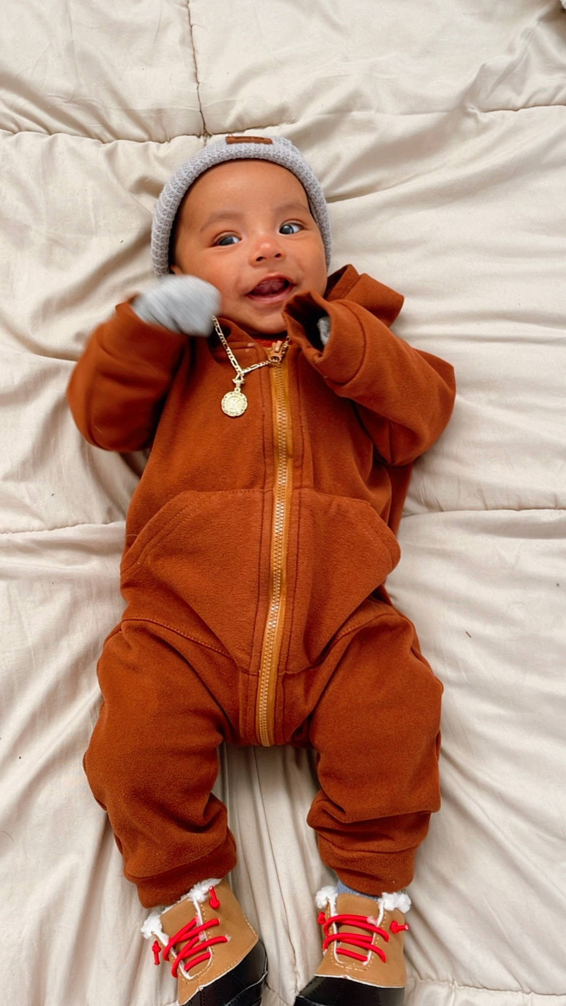 Kairo is registered to the contest to win money with this photo: baby, baby_products, baby_toddler_clothing, cheek, comfort, eye, face, fur, gesture, glove, happy, headwear, jacket, linens, nose, orange, outerwear, person, skin, sleeve