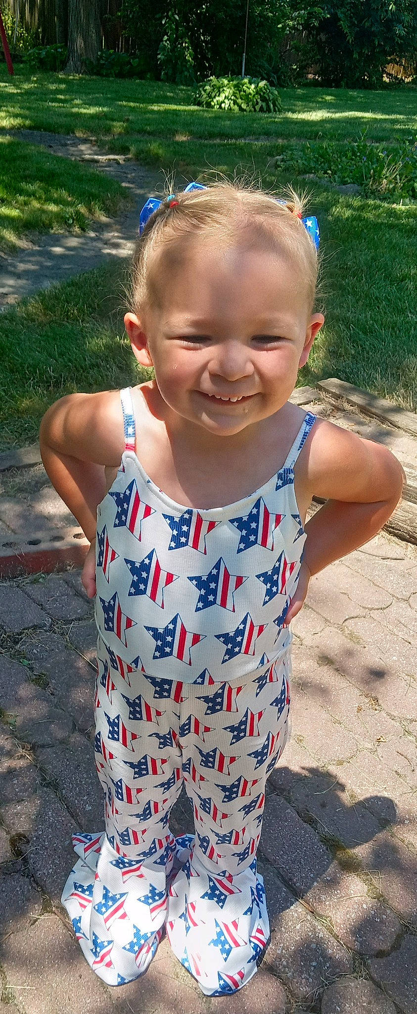 Jenna is registered to the contest to win money with this photo: baby_toddler_clothing, eye, face, fun, grass, hair, hairstyle, happy, head, iris, joy, leaf, leisure, mammal, neck, person, plant, skin, sleeve, smile