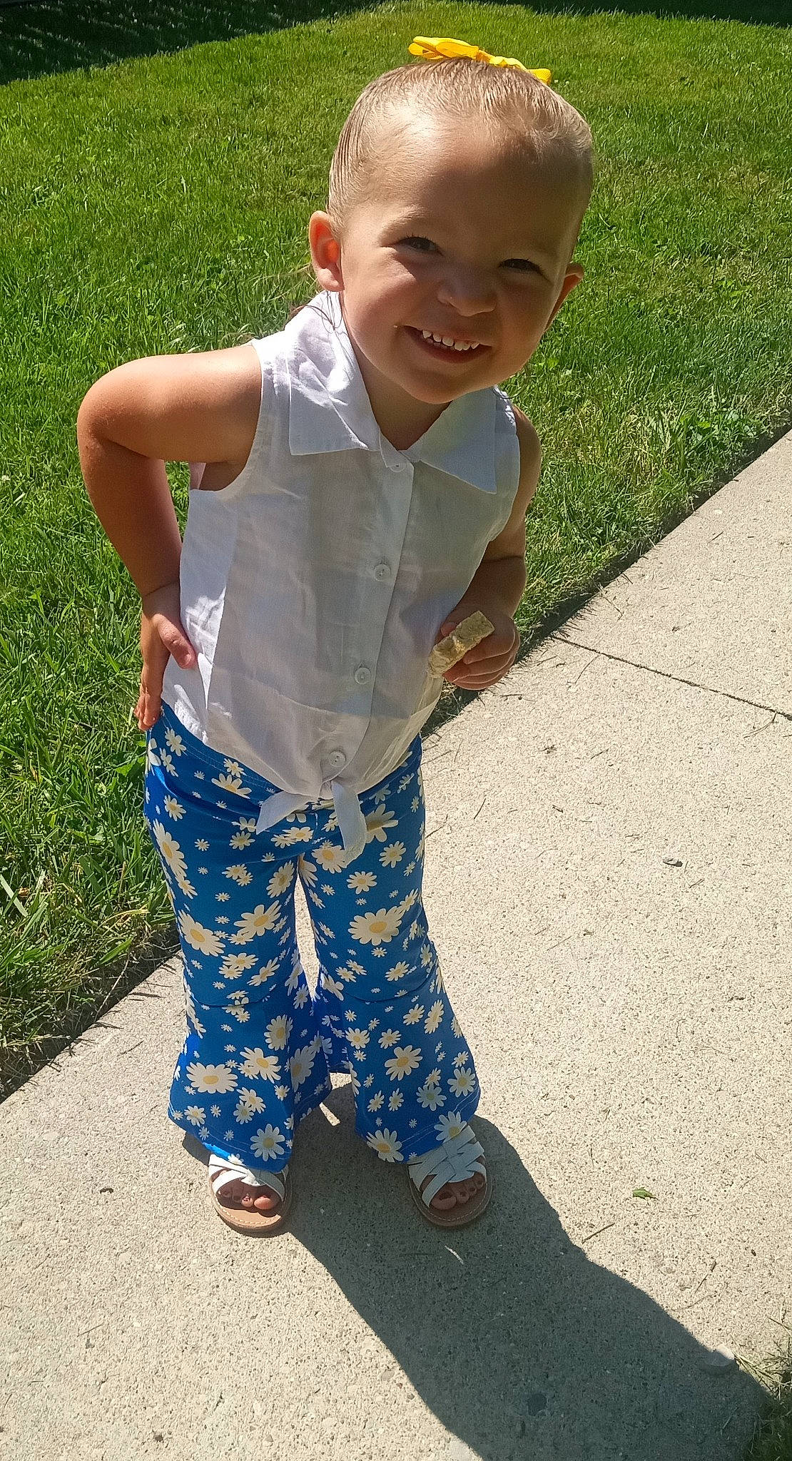 Jenna is registered to the contest to win money with this photo: baby, baby_toddler_clothing, child, electric_blue, face, fun, gesture, grass, hair, happy, head, human_leg, joy, lawn, leisure, pattern, people_in_nature, person, sleeve, smile