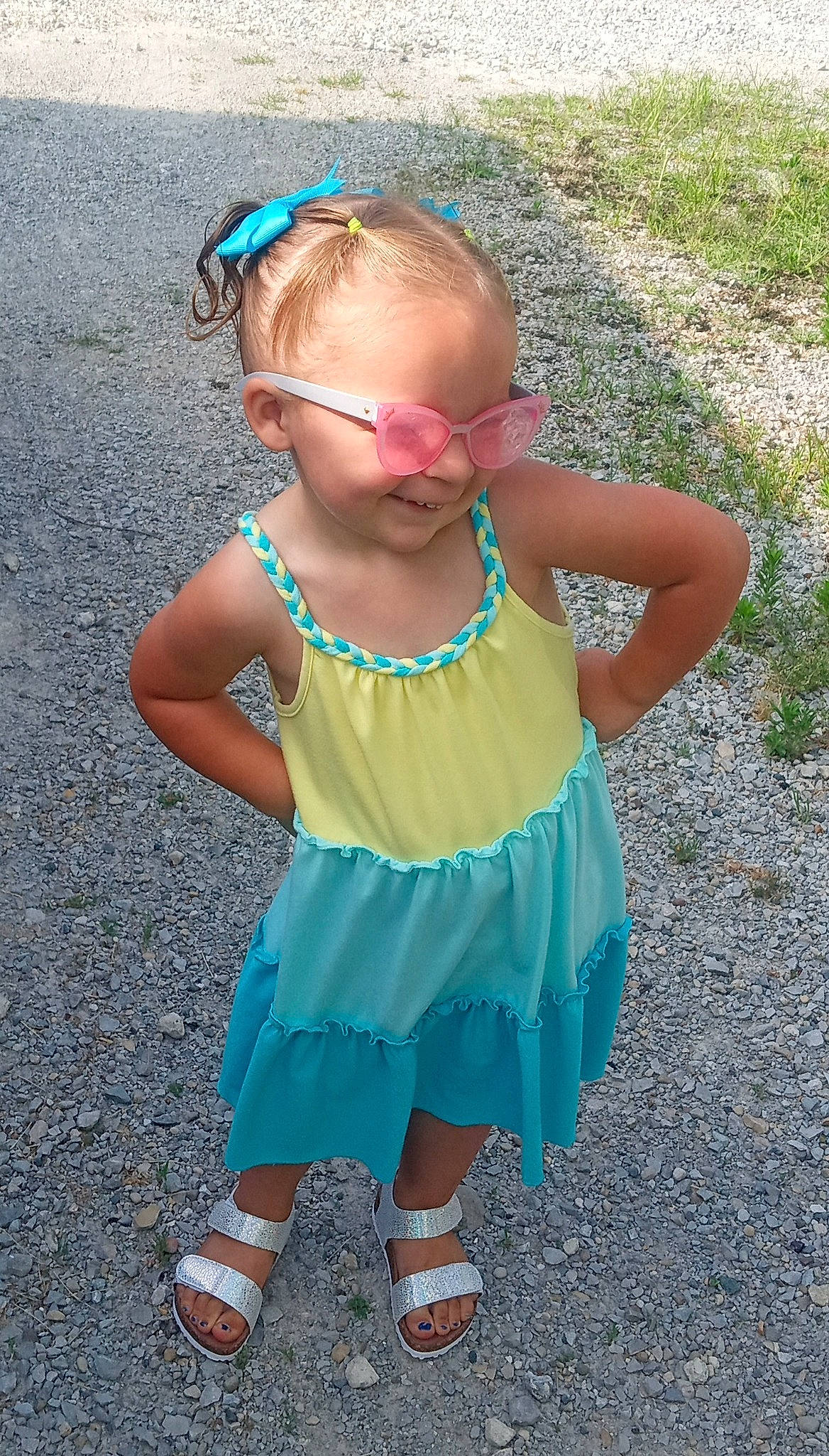 Jenna is registered to the contest to win money with this photo: baby_toddler_clothing, blue, child, day_dress, dress, electric_blue, eyewear, face, fun, grass, green, hair, hairstyle, happy, head, jewellery, magenta, pattern, person, pink