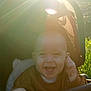 baby, child, smile, stroller, sunlight, lens_flare, happy, outdoor, infant, clothing, hand, face, portrait, nature, daylight, cute, joy, baby_clothes, young_child, toddler