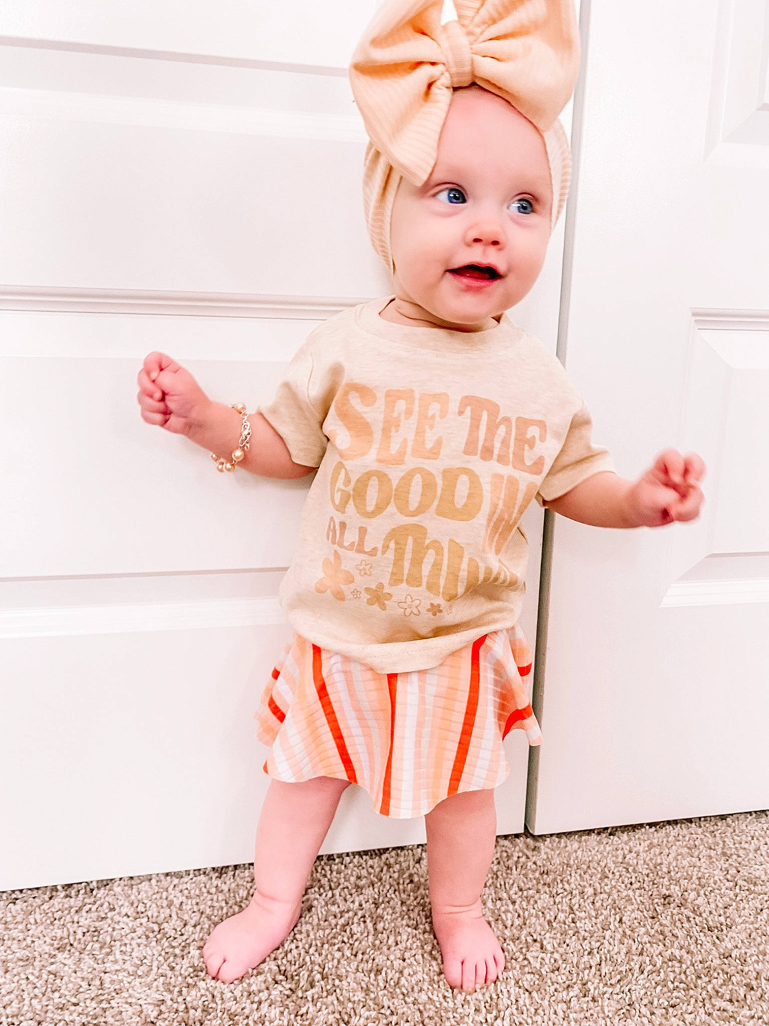 Elaina is registered to the contest to win money with this photo: arm, baby, baby_toddler_clothing, clothing, dress, face, facial_expression, happy, human_body, leg, neck, outerwear, person, pink, shorts, shoulder, skin, sleeve, standing, t_shirt