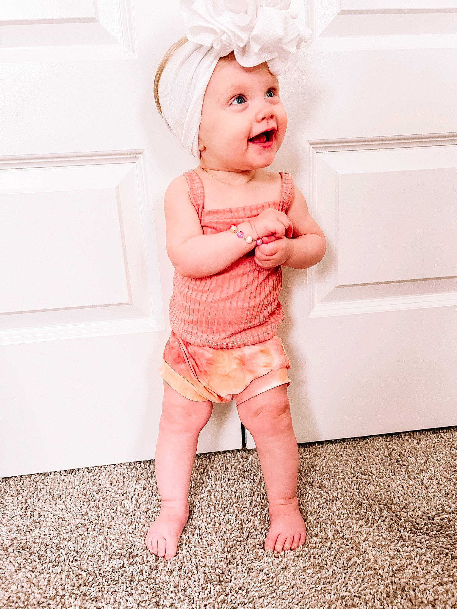Elaina is registered to the contest to win money with this photo: baby, baby_toddler_clothing, chin, clothing, flash_photography, flooring, gesture, hand, happy, head, headwear, human_leg, leg, lip, magenta, nail, person, pink, skin, sleeve