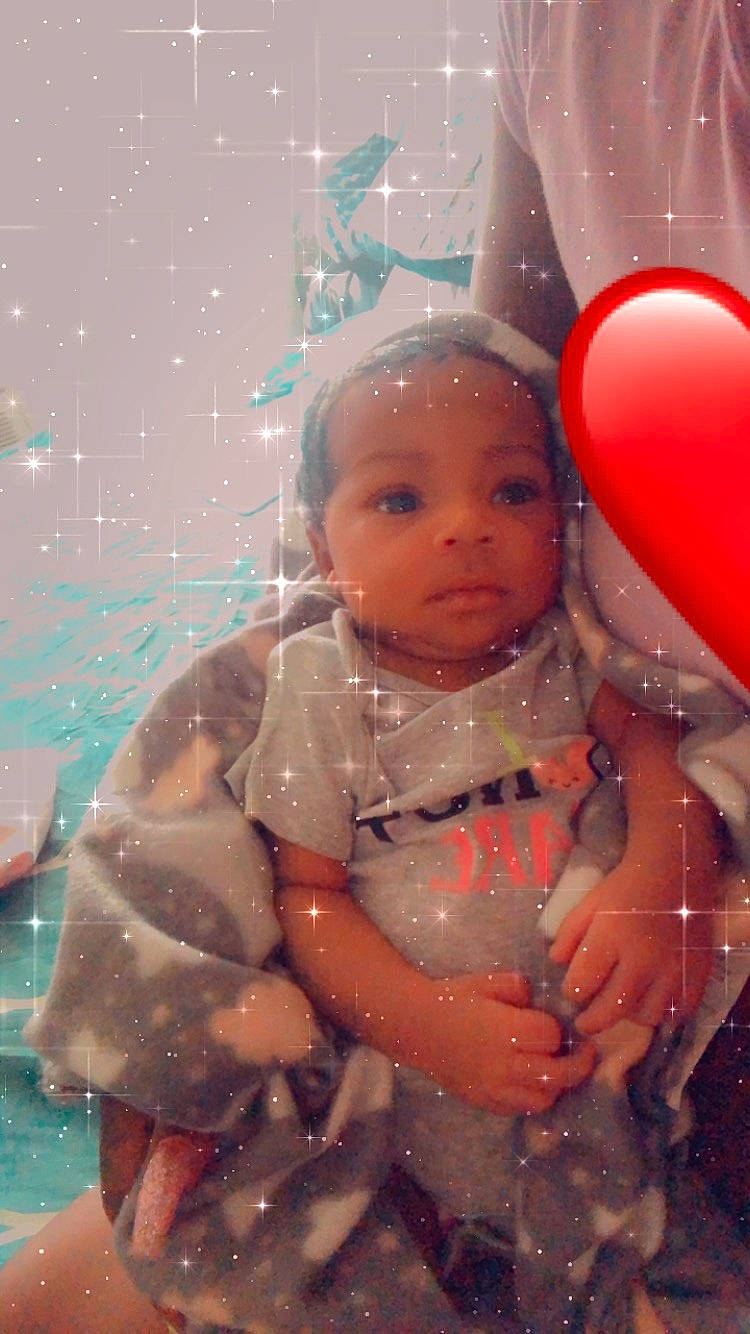 Juliet is registered to the contest to win money with this photo: arm, baby, baby_toddler_clothing, balloon, cheek, child, dress, event, eye, face, fun, hand, happy, head, human_body, lip, person, pink, skin, standing