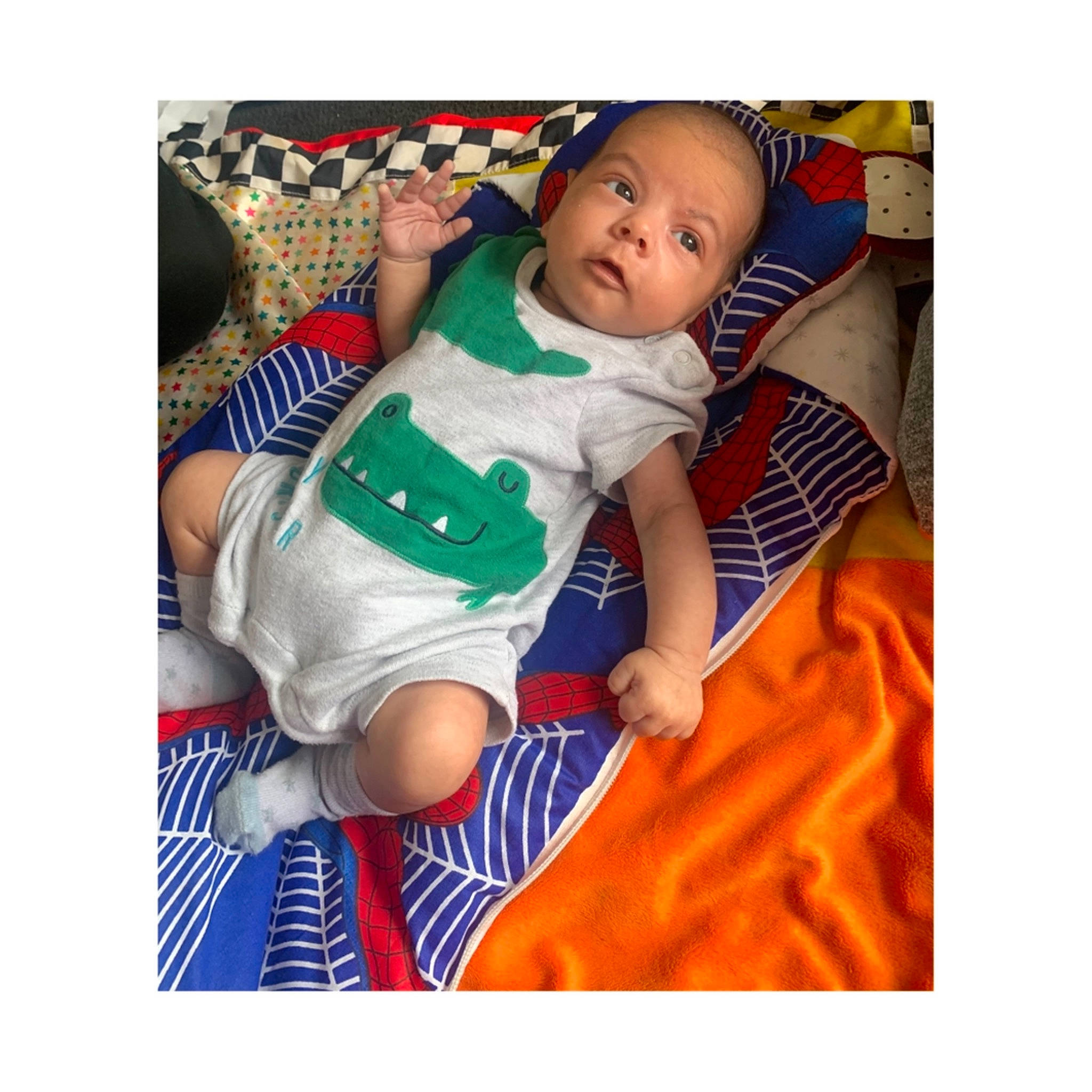 Khalil is registered to the contest to win money with this photo: baby, baby_products, baby_safety, baby_sleeping, baby_toddler_clothing, comfort, dress, electric_blue, face, happy, head, linens, person, shorts, sleeve, smile, sock, t_shirt, textile, thigh