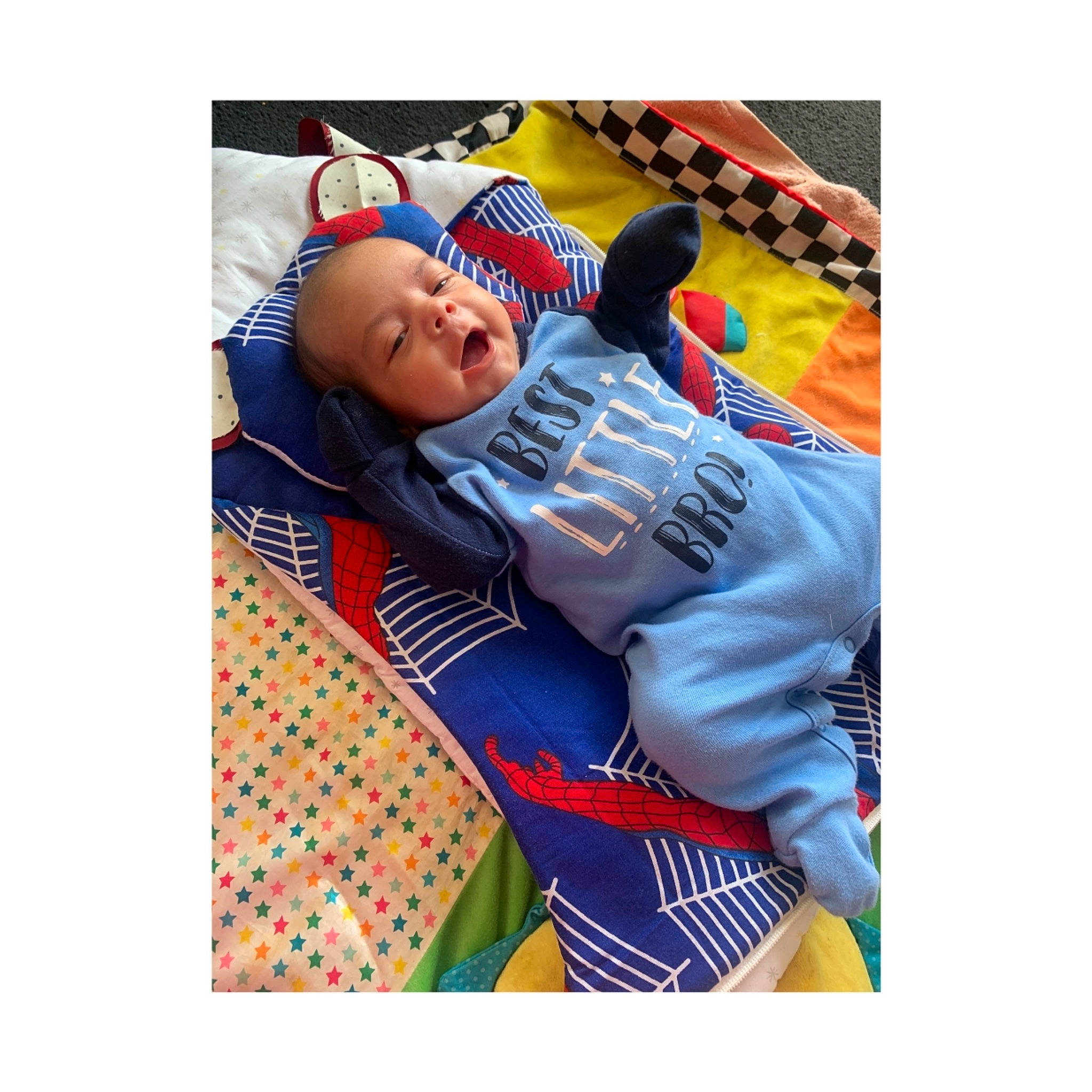 Khalil is registered to the contest to win money with this photo: baby, baby_toddler_clothing, comfort, couch, denim, electric_blue, font, happy, jersey, linens, pattern, person, personal_protective_equipment, shirt, shorts, sleeve, sports_uniform, sportswear, t_shirt, toddler