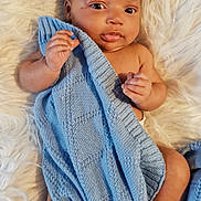 Tavontae is registered to the contest to win money with this photo: baby, infant, blanket, blue_blanket, knitted, soft_texture, fluffy, white_background, cute, skin, hand, foot, lying_down, portrait, newborn, child, face, eyes, fingers, warm