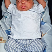 Tavontae is registered to the contest to win money with this photo: animal_print, baby, blanket, boat_print, child, cozy, cute, indoors, infant, newborn, pattern, peaceful, portrait, resting, sleeping, socks, soft, striped_pants, toddler, white_shirt