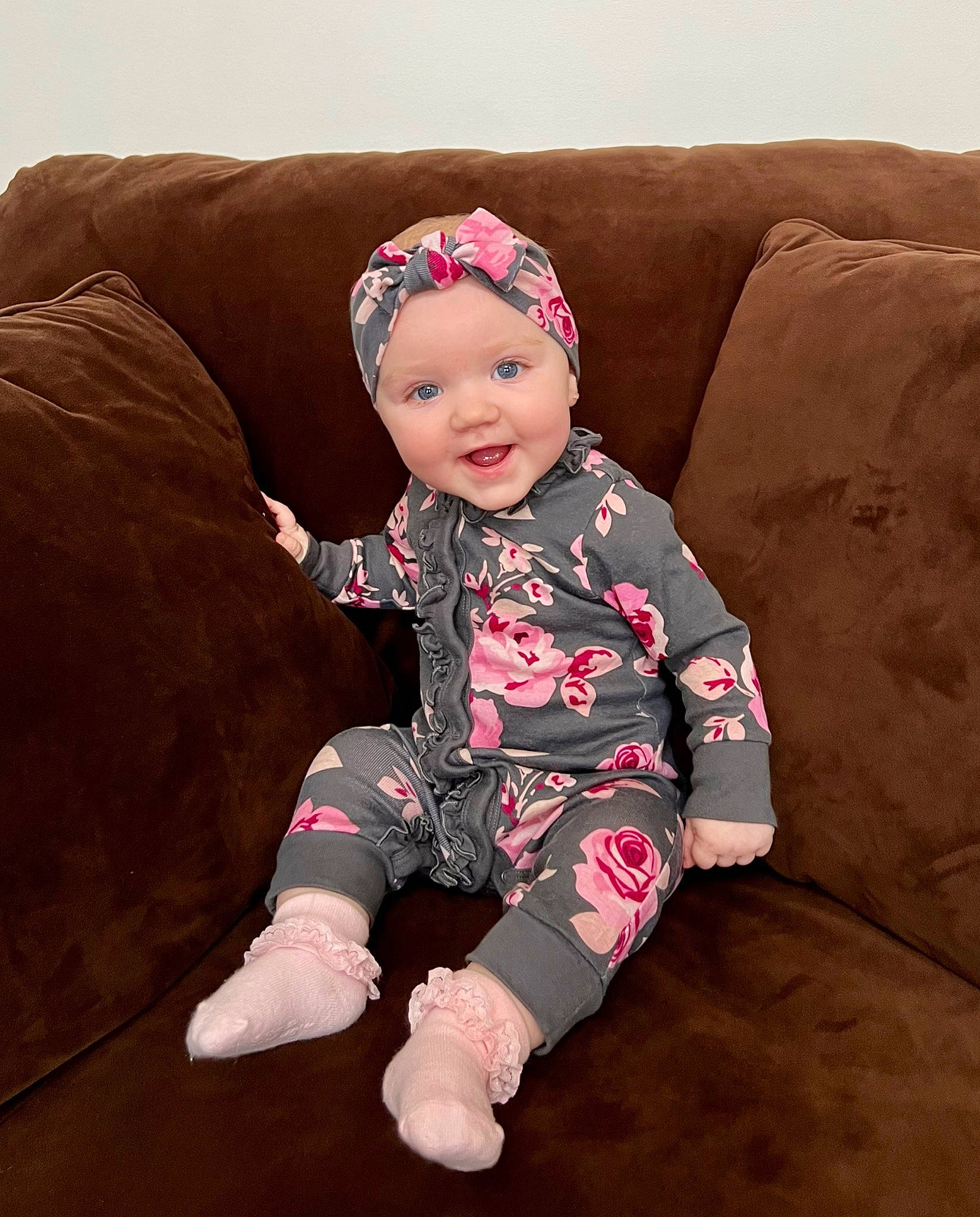 Natalie is registered to the contest to win money with this photo: baby, baby_toddler_clothing, comfort, costume_hat, couch, eye, foot, happy, head, headwear, human_body, human_leg, knee, lap, leg, pattern, person, sleeve, smile, sock